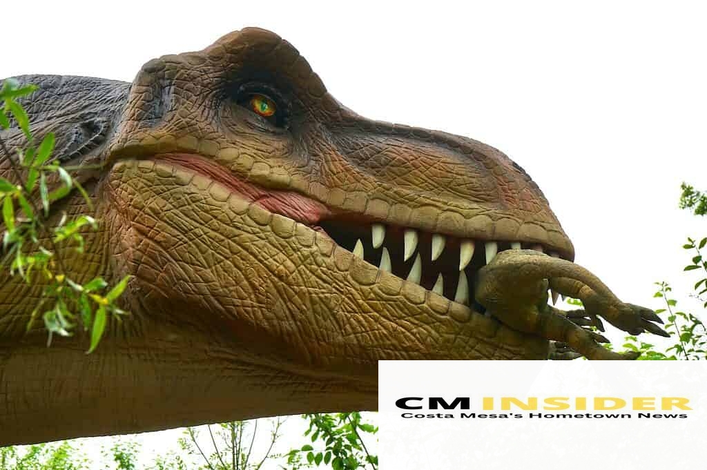 low angle photo of dinosaur eating baby dinosaur